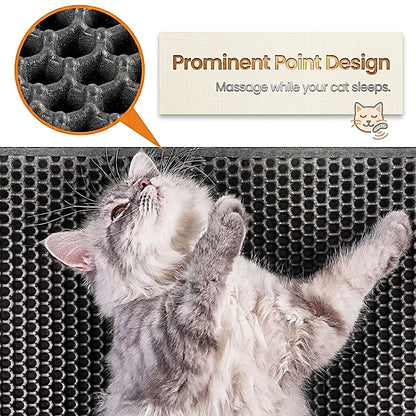 A gray and white cat lies on its back on a black honeycomb-textured pet mat, with a callout inset showing the raised point texture and text reading 'Prominent Point Design' and 'Massage while your cat sleeps.'.